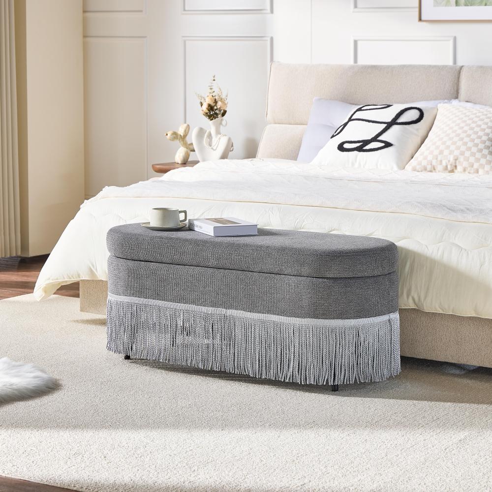 Oval Upholstered Storage Ottoman with Fringe Trim & Lift-Top Lid - 39"L x 16"W x 17"H, Multi-Functional Footrest & Hidden Storage for Living Room or Bedroom - Grey Fabric with Metal Frame