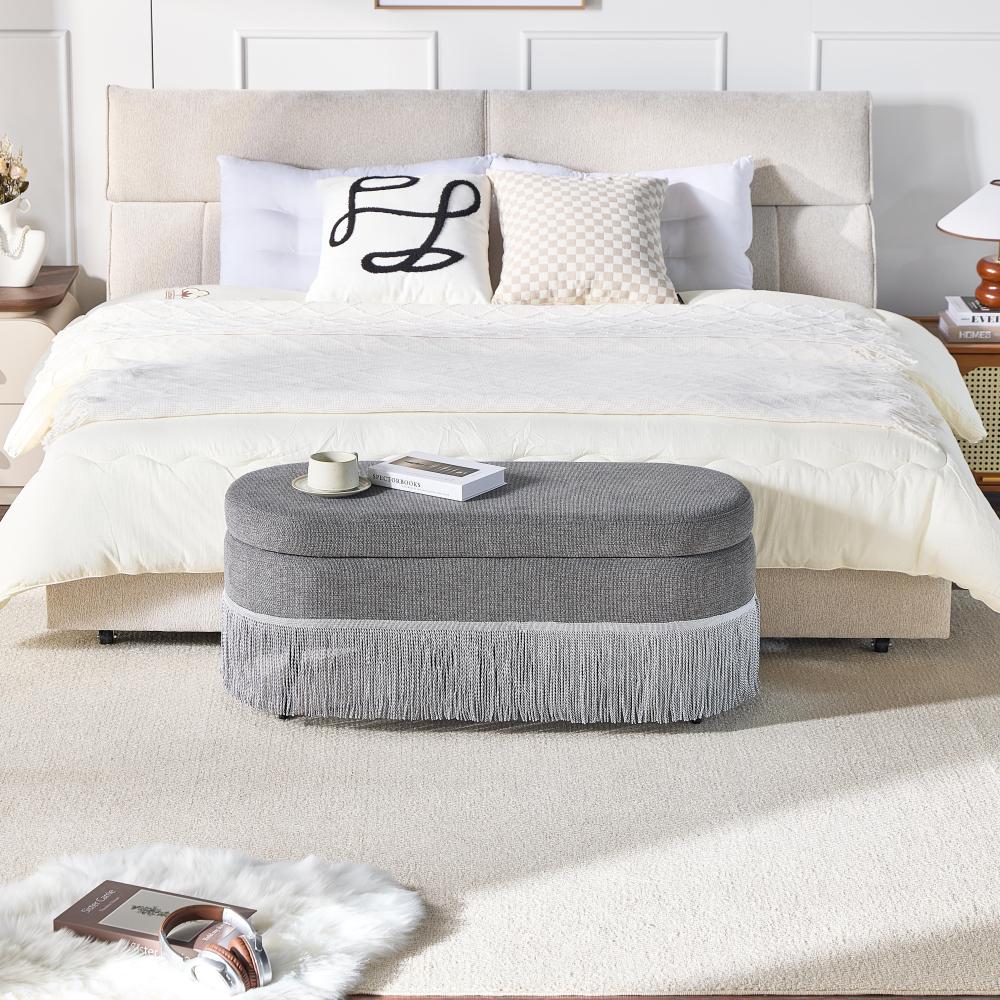 Oval Upholstered Storage Ottoman with Fringe Trim & Lift-Top Lid - 39"L x 16"W x 17"H, Multi-Functional Footrest & Hidden Storage for Living Room or Bedroom - Grey Fabric with Metal Frame